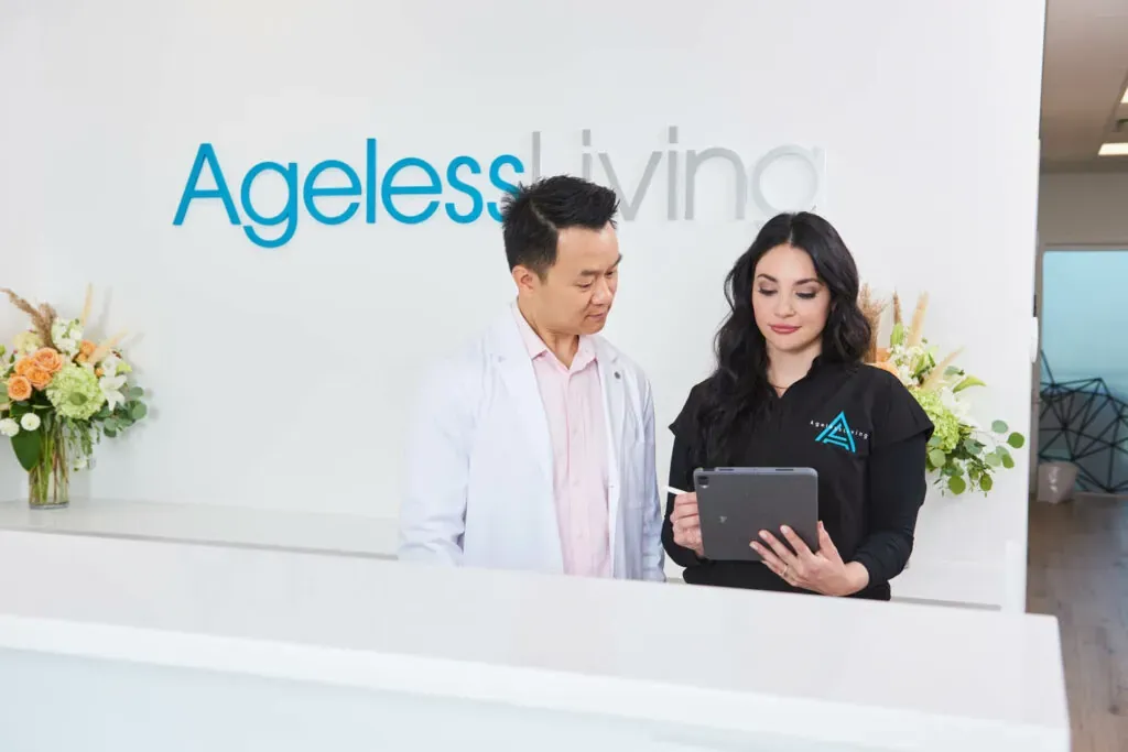 Two practitioners going over notes at the clinic's front desk
