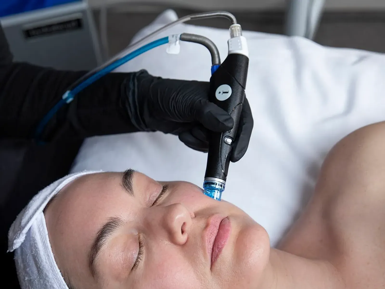 A patient receiving a hydradermabrasion UltraFacial treatment at Ageless Living