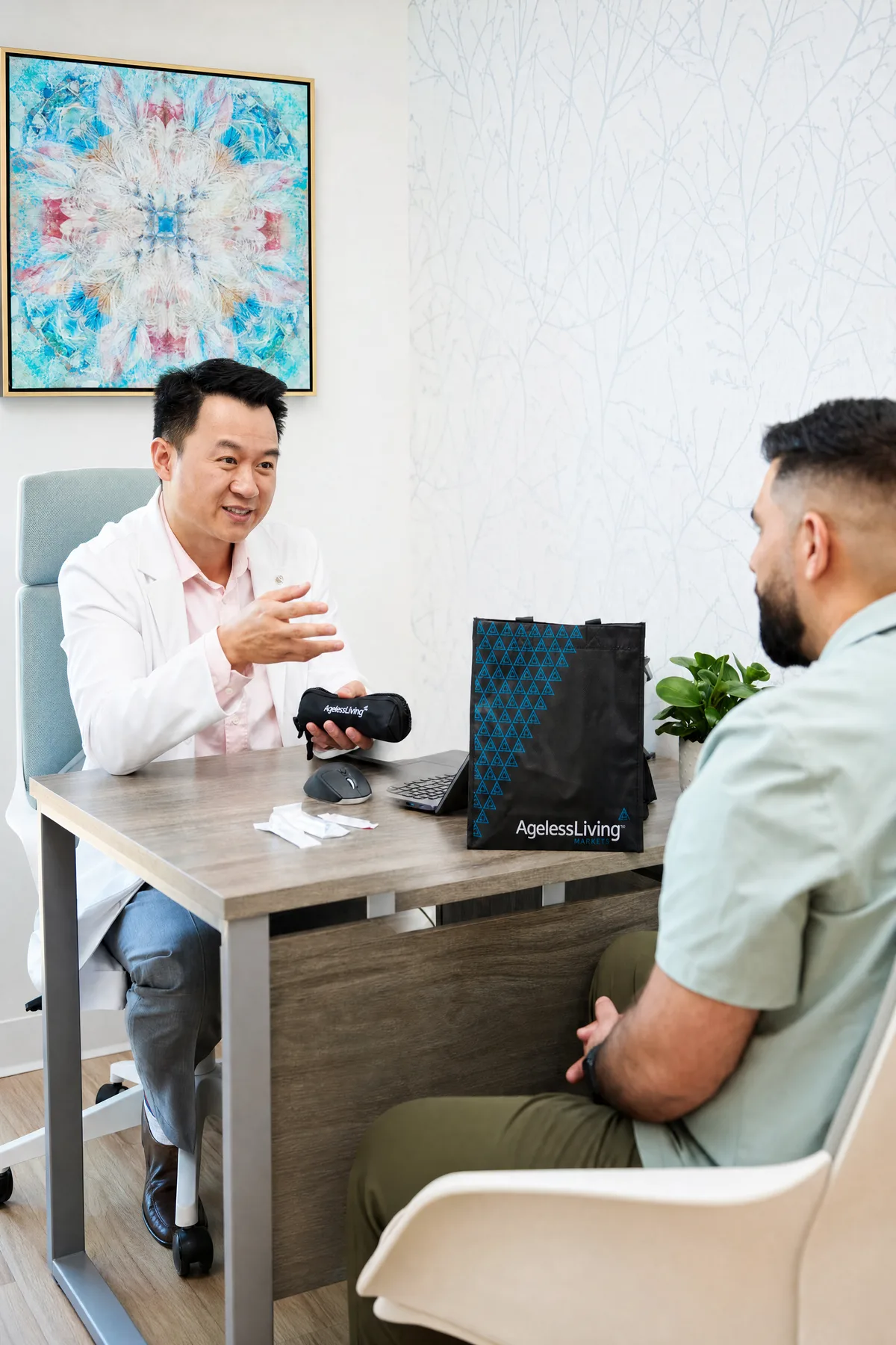 A practitioner in a white coat across a desk from a client, talking through a product